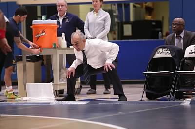 Wrestling coach Pat Pecora observes a bout against Mercyhurst last season, telling wrestlers what to do during the match.