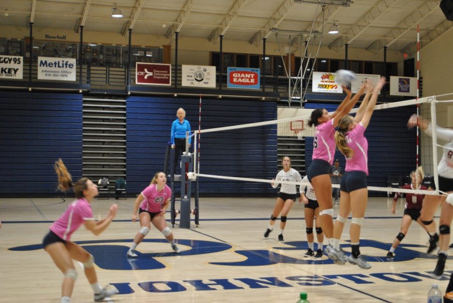 Junior Caitlin Vrabel and sophomore J.C. Longeville leap to defend against Lock Haven Friday at the Sports Center. Pitt-Johnstown ended up winning the game, 3-1. Since starting 4-6, the team has improved, going 9-2 in their last 11 games.