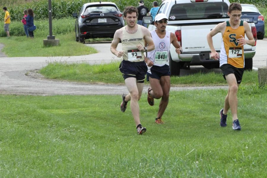 Junior Connor Harriman (left) runs in the St. Vincent’s Invitational on Sep. 15 in Latrobe, Pa.