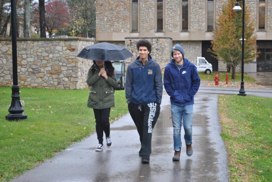 Sophomores Chloe Guerra, Zach Davis and Richard Hartnett brave the cold, wind and rain Friday with fall jackets. 