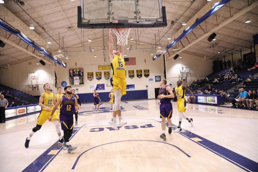 Freshman Caiden Landis (15) dunks the basketball in a game against Carlow University on Nov. 28 at the Sports Center. The team dominated, the game, winning 129-69.