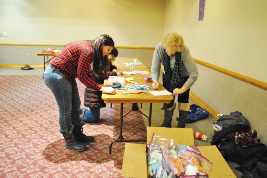 Yamila Audisio, senior (left), Tulsi Shrivastava, senior (center), and Cindy Orlovsky, alumna (right), assemble toiletry bags for The Women’s Help Center during the College Democrat meeting Jan. 19, since the trip to the Women’s March in New York City was canceled.