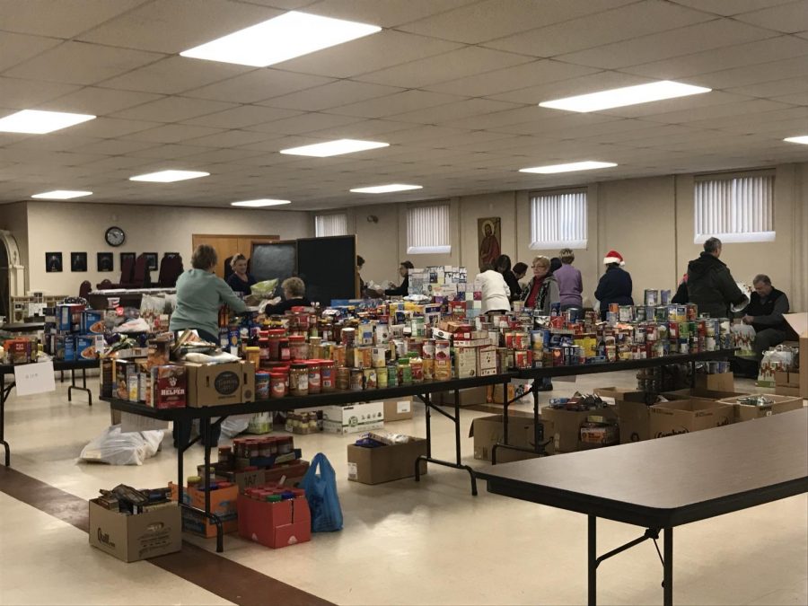 Members of local churches organize supplies donated to the St. Vincent de Paul Soup Kitchen.  The groceries were given to local this past Christmas season.  
| Photo courtesy of LaDonna McCrary