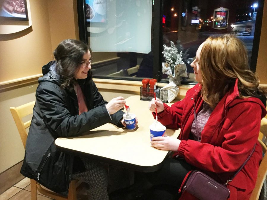 Juniors Jaymie Harclerode (left) and Mikayla Haggerty (right) eat Blizzards from the Dairy Queen along Scalp Avenue.  Dairy Queen is one of the Pitt Stop locations that offer discounts for Pitt-Johnstown community members. 