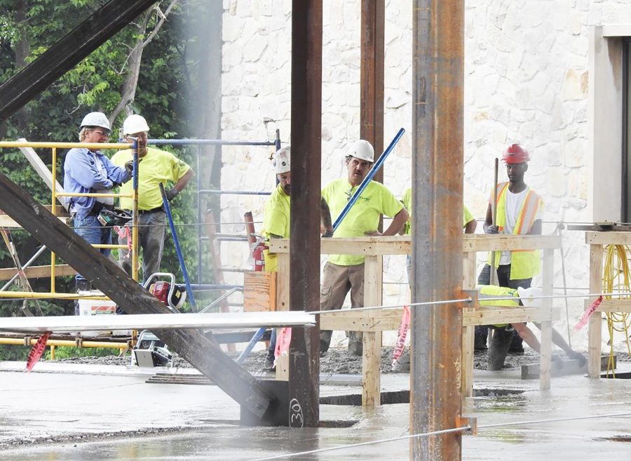 Massaro Corp. workers consider their work during July construction of the John P. Murtha Engineering and Science building’s chemical enginnering addition. The construction was to be finished by Jan. 1, but campus officials have said that it will wrap up soon.