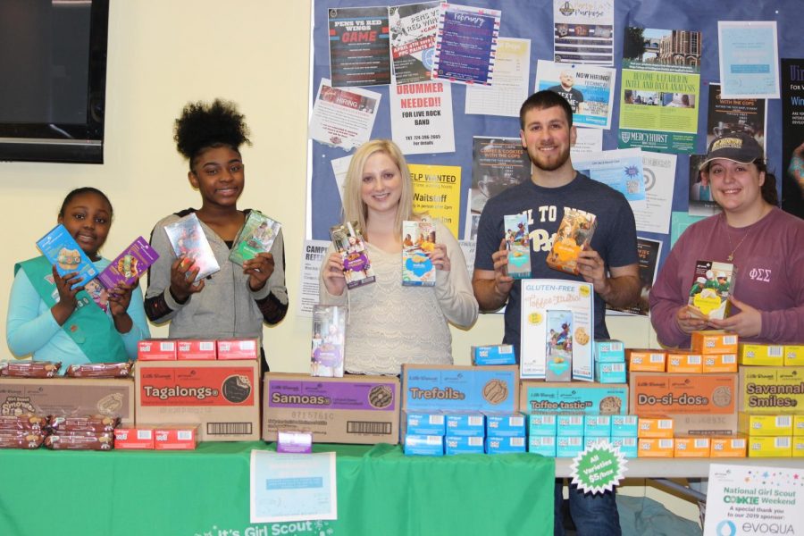 Girl Scout Ariyana Mays (left), junior Madison Kriak (middle) and sophomore Michael Garancsi (right) sold Girl Scout cookies last Friday on the Student Union ground floor.
