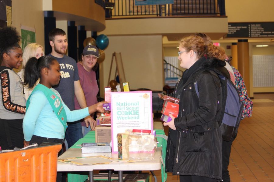 Lacey Mays (front), who is a Girl Scout, sold cookies with her sister, Ariyana Mays (left), last Friday in the Student Union.