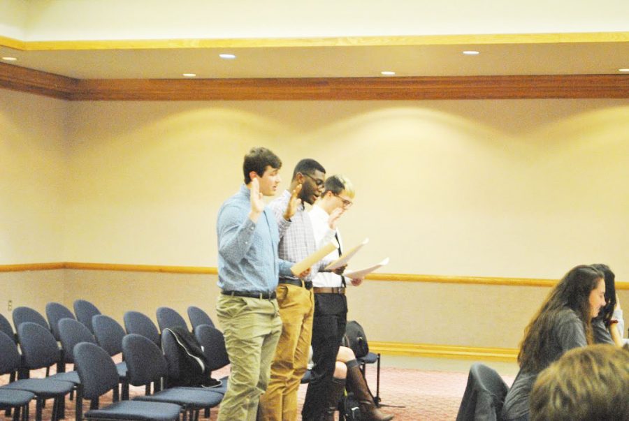 New student government senators Ryan Clark (left), Kyle Quartes Jr. (center) and Brant Durham (right) get sworn in during a Feb. 4 meeting.