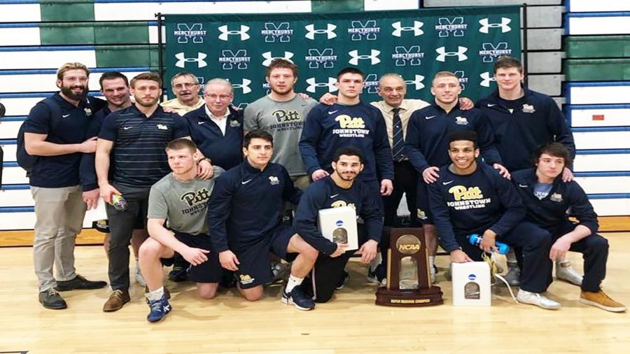 Pitt-Johnstown wrestlers pose with their regional trophy after winning their regional tournament Feb. 23 in Erie, Pa.