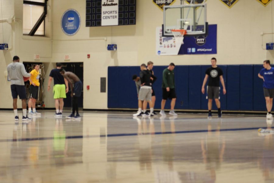 Women’s head coach Mike Drahos second from right helps the men’s basketball team for their pick-up game in the Sports Center March 20.