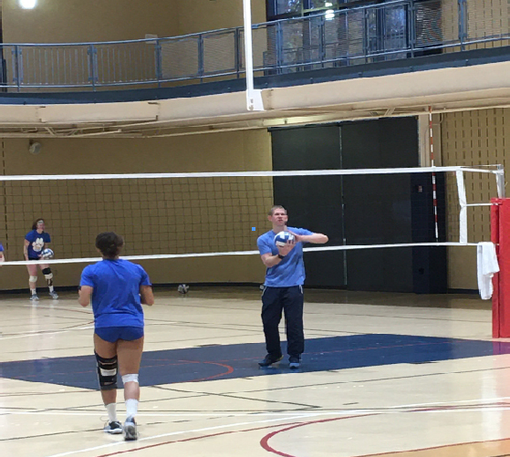 Justin Haupt (right), coaches the women’s volleyball team in the Wellness Center.