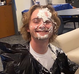 FirstGen President Michael Baker gets pied in the face at a FirstGen Club event.
